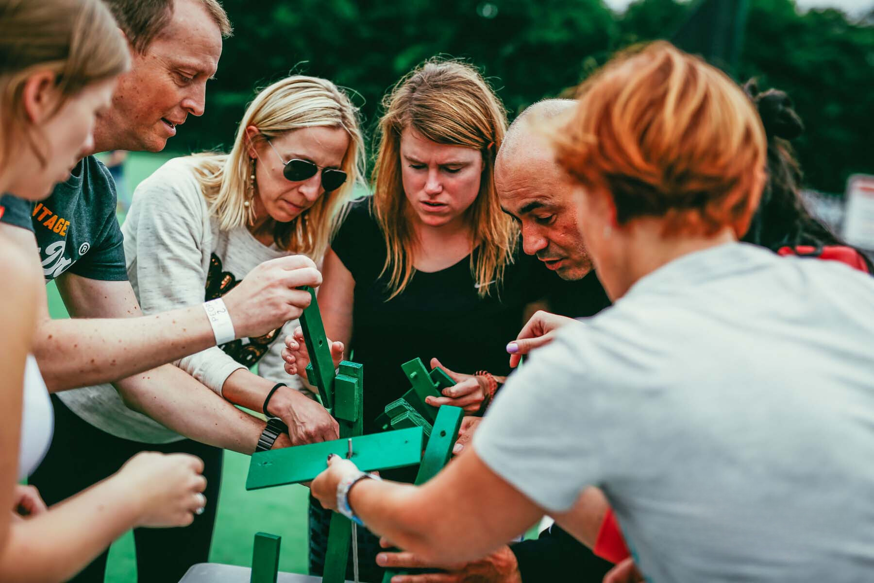 group of people completing a collaborative assembly challenge