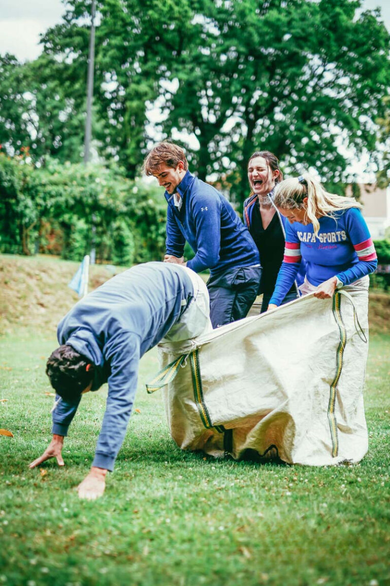 group of people doing a bags race in the open air