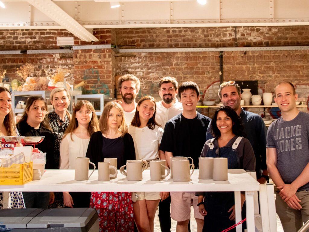 Group photo at the end of a ceramics workshop with their creations