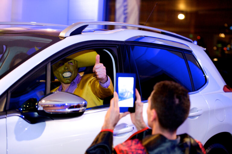 person dressed up in a car, in the middle of an improvised film shoot during a team building movie play