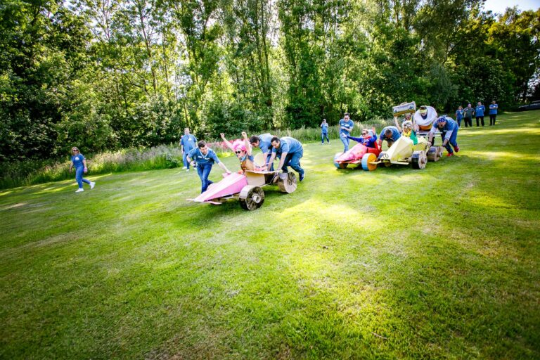 Team-building race with cardboard cars made by participants