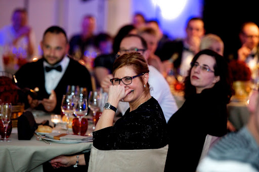 Attentive and amused guests at a dinner and show organised for a corporate team-building event