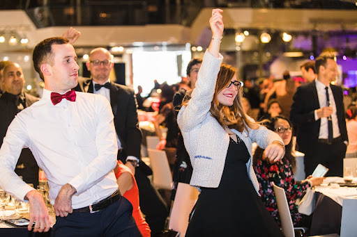people dancing and having fun at a team-building dinner and show