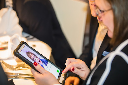 someone using an interactive tablet during a dinner show as part of a team-building activity