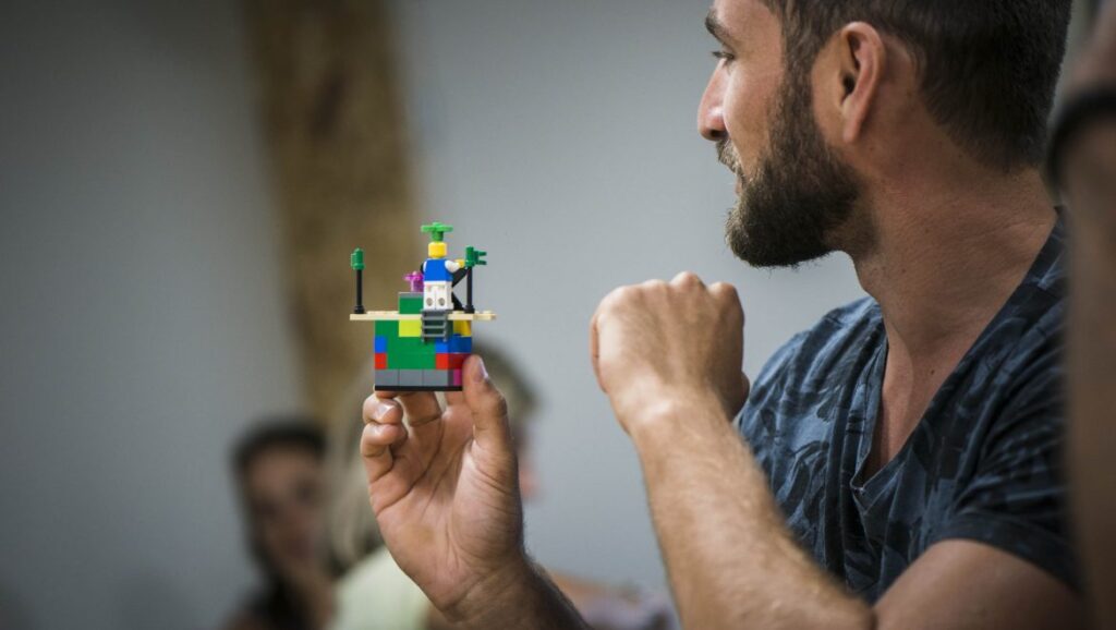 presentation of a creative Lego construction during a collaborative team building challenge