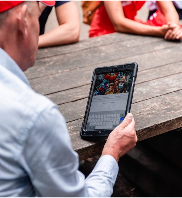 Person using a tablet for an interactive team game at an event