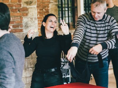 A moment of complicity and laughter between colleagues during a team building workshop where they take on challenges