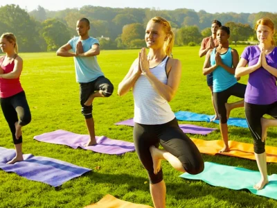group yoga session in a green outdoor setting