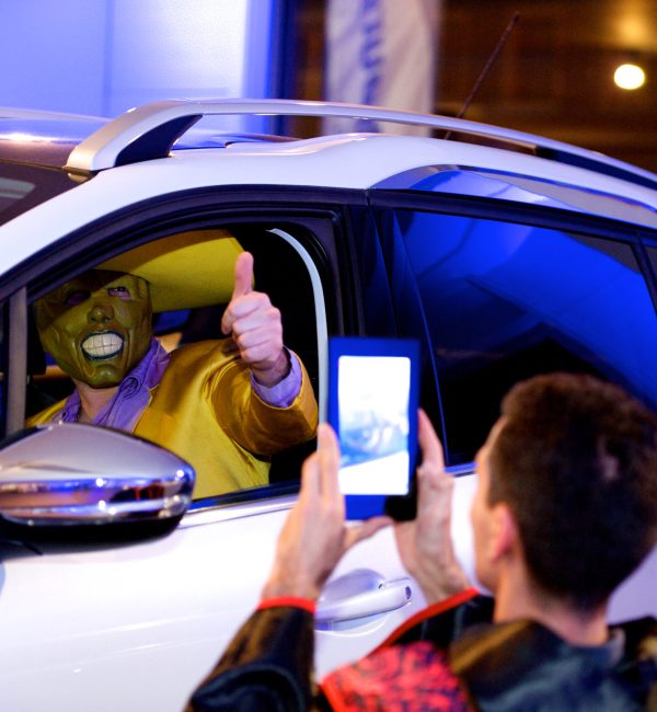 person dressed up in a car, in the middle of an improvised film shoot during a team building movie play