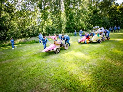 Team-building race with cardboard cars made by participants