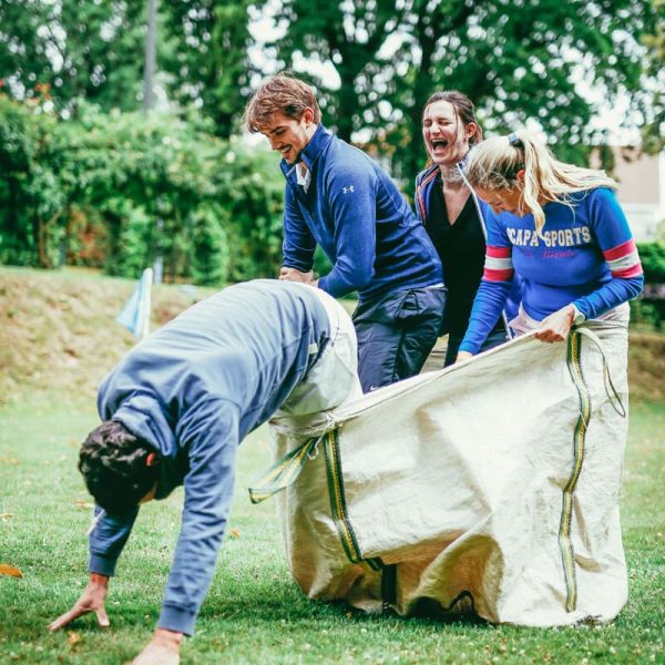 group of people doing a bags race in the open air